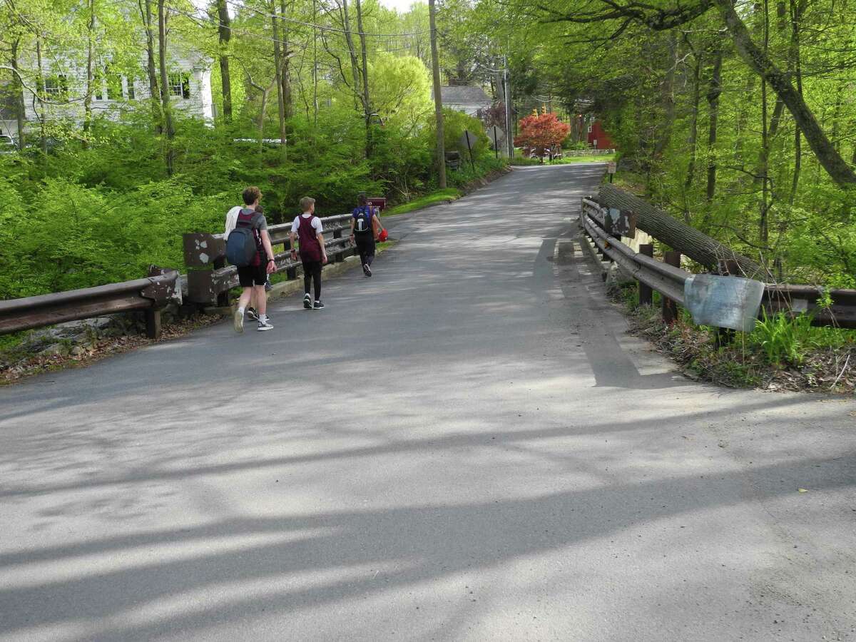 Pedestrians walk from Merwin Meadows along the bridge on Lovers Lane. A public meeting on replacing the bridge will take place electronically on Oct. 15.