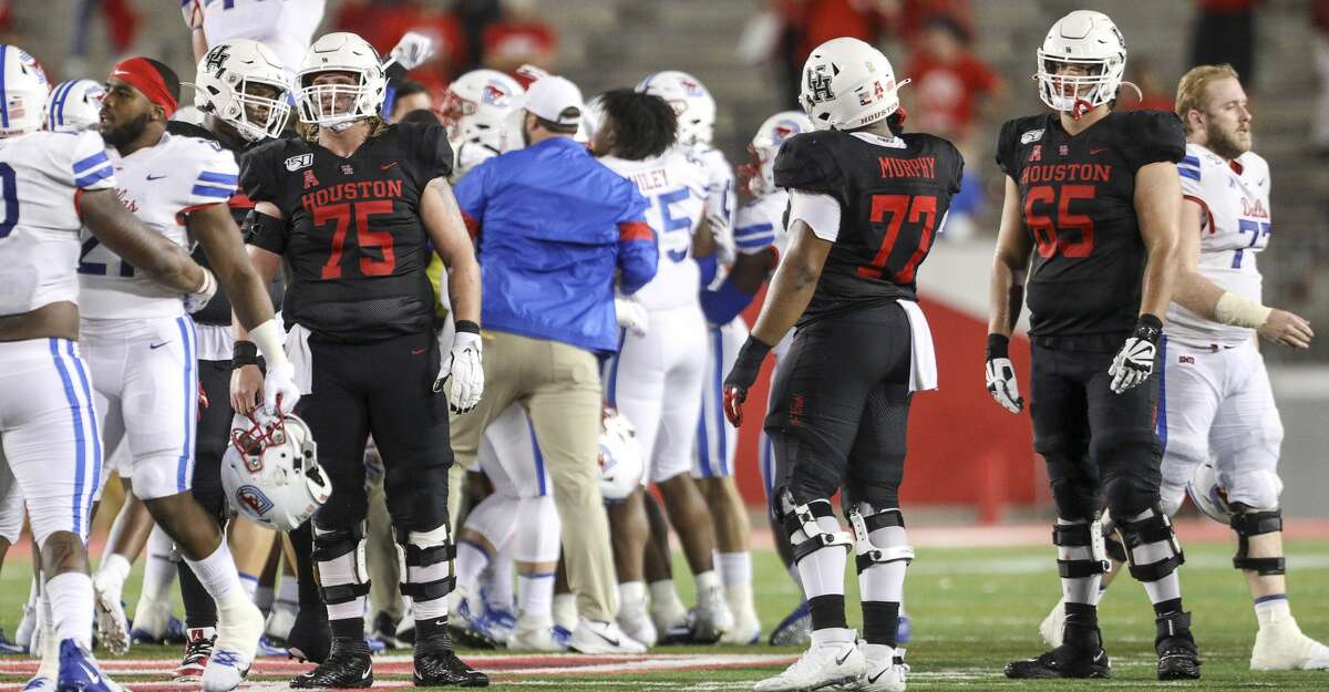 Houston Cougars offensive lineman Jack Freeman (75), offensive lineman Keenan Murphy (77) and offensive lineman Gio Pancotti (65) watch as the SMU Mustangs celebrate after beating the Houston Cougars in an NCAA football game at TDECU Stadium on Thursday, Oct. 24, 2019, in Houston.
