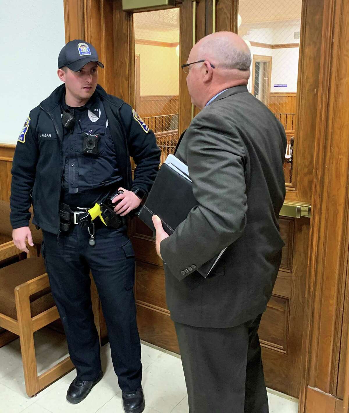 One of the two Ansonia police officers who responded to attorney Fred Dorsey’s call to have Mayor David Cassetti removed talks to the school board lawyer. Dorsey declined time file a complaint because the mayor had left after adjourning the meeting.