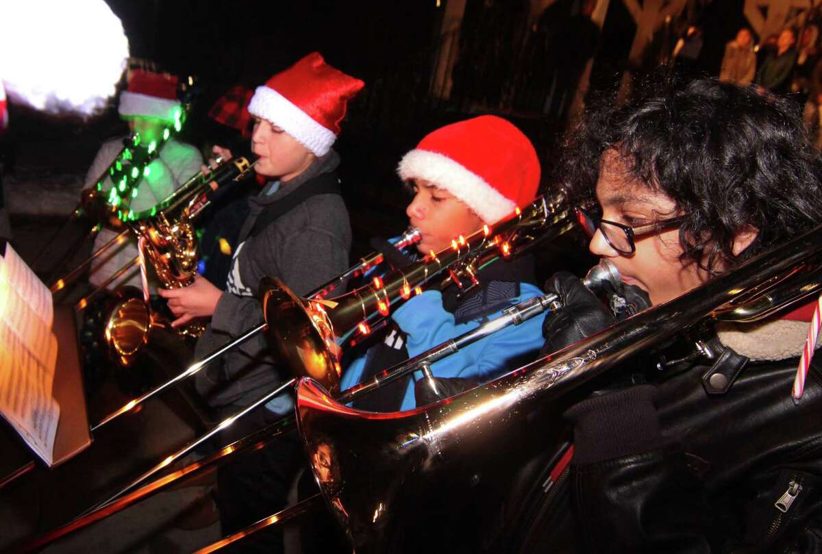 Students from the Madison Elementary School band perform Christmas songs during the annual holiday tree lighting event at Town Hall Green in Trumbull, Conn., on Friday Dec. 6, 2019.