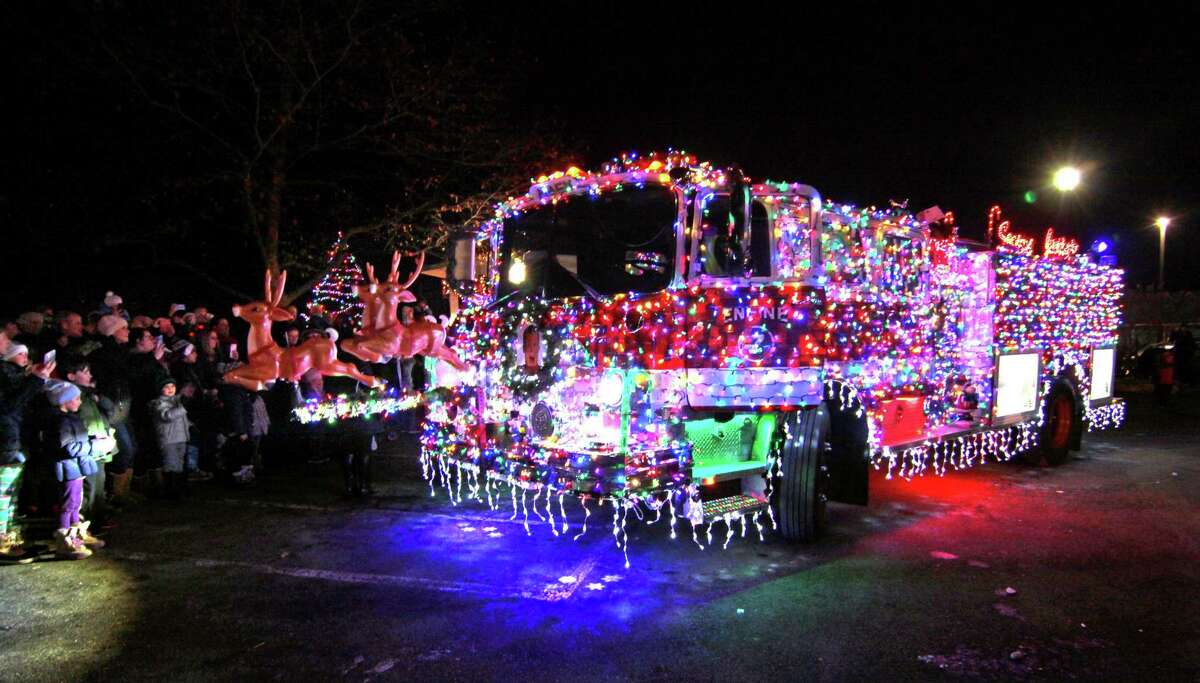 Santa arrives in his "sleigh," the Long Hill Fire Department Christmas truck during the annual holiday tree lighting event at Town Hall Green in Trumbull, Conn., on Friday Dec. 6, 2019.