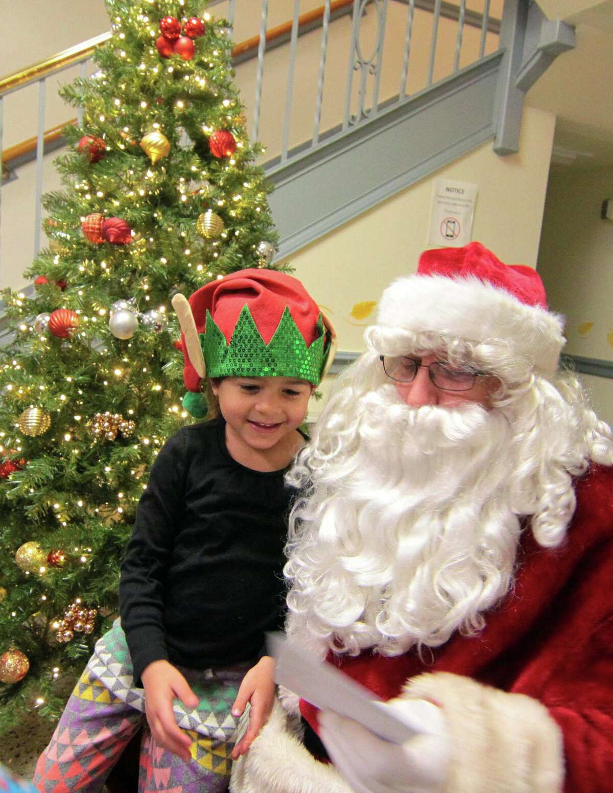 Santa visits with the children during the annual holiday tree lighting event at Town Hall Green in Trumbull, Conn., on Friday Dec. 6, 2019.