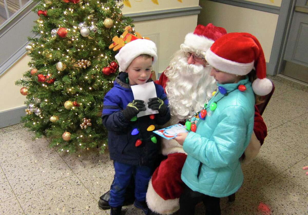 Santa visits with the children during the annual holiday tree lighting event at Town Hall Green in Trumbull, Conn., on Friday Dec. 6, 2019.