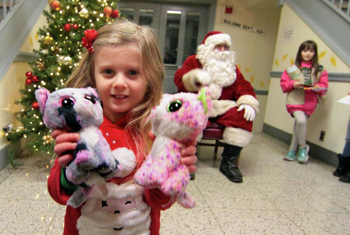 Santa visits with the children during the annual holiday tree lighting event at Town Hall Green in Trumbull, Conn., on Friday Dec. 6, 2019.