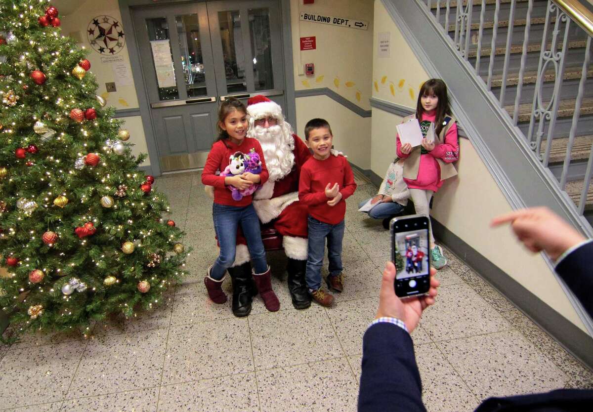 Santa visits with the children during the annual holiday tree lighting event at Town Hall Green in Trumbull, Conn., on Friday Dec. 6, 2019.
