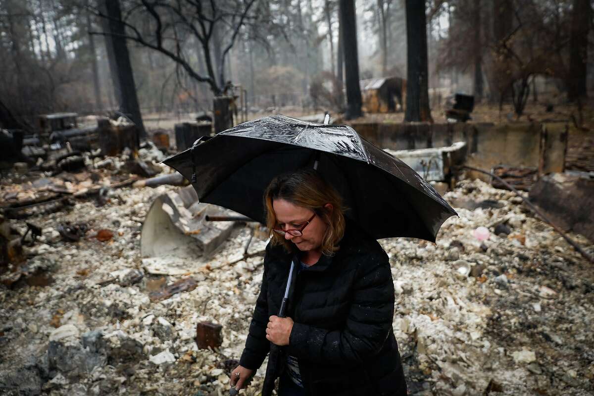 Suzanne Kaksonen looks through her property for the first time after the Camp Fire tore through the area on Wee Dell Road in Paradise, California, on Sunday, Dec. 16, 2018.