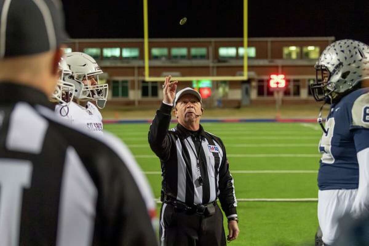 The referee tosses the coin to start the quarterfinal match between the Silsbee Tigers and the Mustangs of West Orange-Starke on Friday night at BISD Memorial Stadium. Fran Ruchalski/The Enterprise