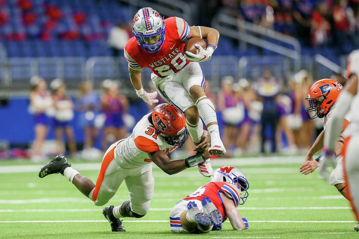 Brandeis’ Jordon Flowers (31) goes low to bring down Austin Westlake’s Zane Minors during the first half at the Alamodome.