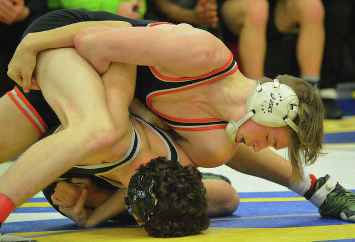 Edwardsville’s Grant Schmid, top, wrestles Whitfield’s Caleb Gagliano at 145 pounds during Saturday’s championship match in the Ron Sauer Duals at Fox High School in Arnold, Mo.