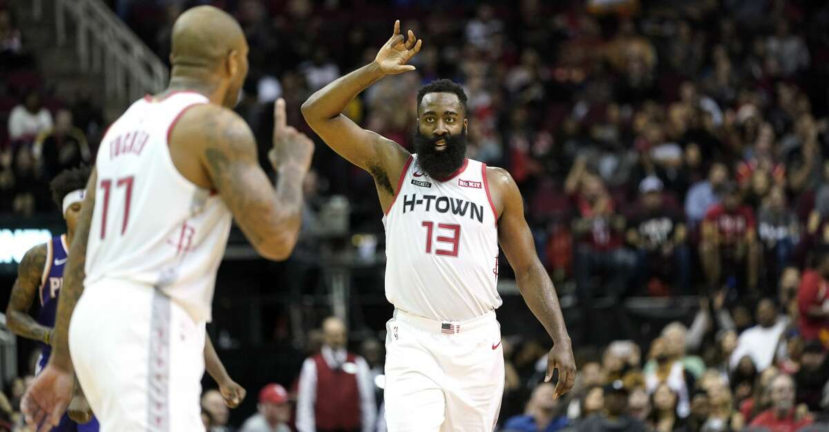 Houston Rockets' James Harden (13) celebrates with PJ Tucker (17) during the second half of an NBA basketball game against the Phoenix Suns Saturday, Dec. 7, 2019, in Houston. The Rockets won 115-109. (AP Photo/David J. Phillip)