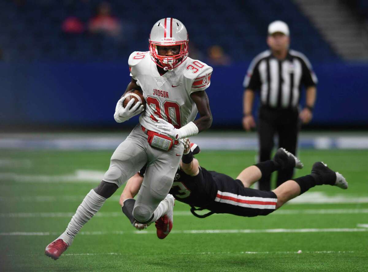 Running back De'Anthony Lewis of Judson evades an Austin West Lake tackler during high school football state quarterfinals action in the Alamodome on Saturday, Dec. 7, 2019.