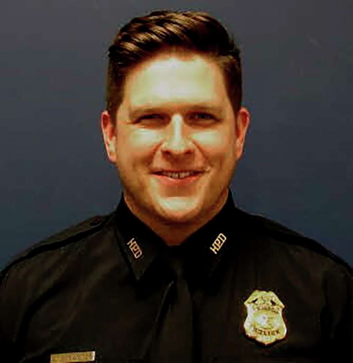 In this undated photo posted on Twitter and provided by the Houston Police Department is Sgt. Christopher Brewster, who was shot and killed Saturday evening, Dec. 7, 2019, by a man who had been reported for assault, authorities said. Police officials said in a tweet that the 32-year-old officer was shot just before 6 p.m. (Houston Police Department via AP)>>>See more for aftermath of the shooting...