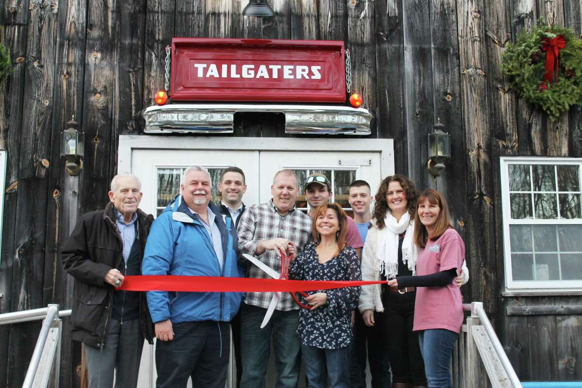Tailgaters Deep River held a grand opening of the pub at 439B Main St. The eatery serves beer, wine and spirits, as well as light fare. From left are Middlesex County Chamber of Commerce President Larry McHugh, Chairman Don DeVivo, Vice President Jeff Pugliese, Tailgaters owners Jim Jake and Brenda Jake, staff members Dean Kollmer and Will Riccio, Deep River selectman’s assistant Gina Sopneski, and Tailgaters staff member Terry Layden.