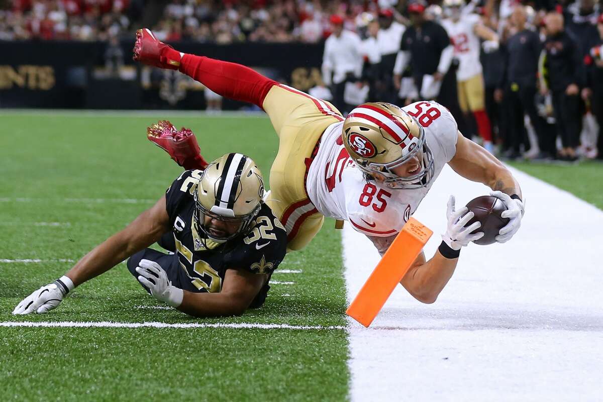 NEW ORLEANS, LOUISIANA - DECEMBER 08: George Kittle #85 of the San Francisco 49ers scores a touchdown as Craig Robertson #52 of the New Orleans Saints defends during the second half of a game at the Mercedes Benz Superdome on December 08, 2019 in New Orleans, Louisiana. (Photo by Jonathan Bachman/Getty Images)
