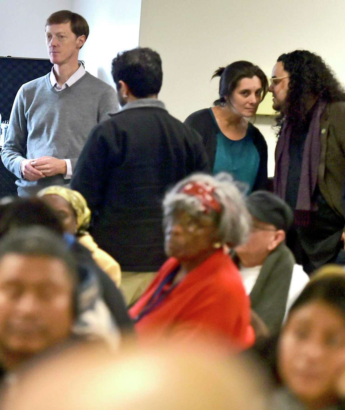 New Haven Mayor-elect Justin Elicker, far left, watches a community meeting for ideas and suggestions on the topics of Economic Development and Education, organized by his transition team, was held Sunday afternoon as the last of a series of meeting held at the High School in the Community in New Haven before Elicker becomes mayor on Jan. 1.