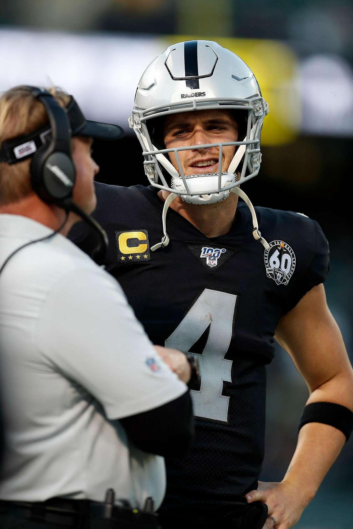 Oakland Raiders' Derek Carr and head coach Jon Gruden during 4th quarter of Raiders' 42-21 loss to Tennessee Titans in NFL game at Oakland Coliseum in Oakland, Calif., on Sunday, December 8, 2019.