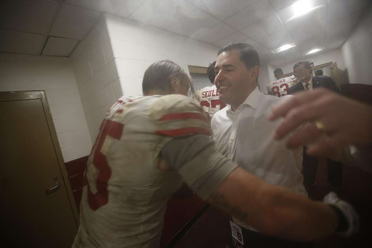 LANDOVER, MD - OCTOBER 20: George Kittle #85 of the San Francisco 49ers is congratulated by CEO Jed York in the locker room following the game against the Washington Redskins at FedExField on October 20, 2019 in Landover, Maryland. The 49ers defeated the