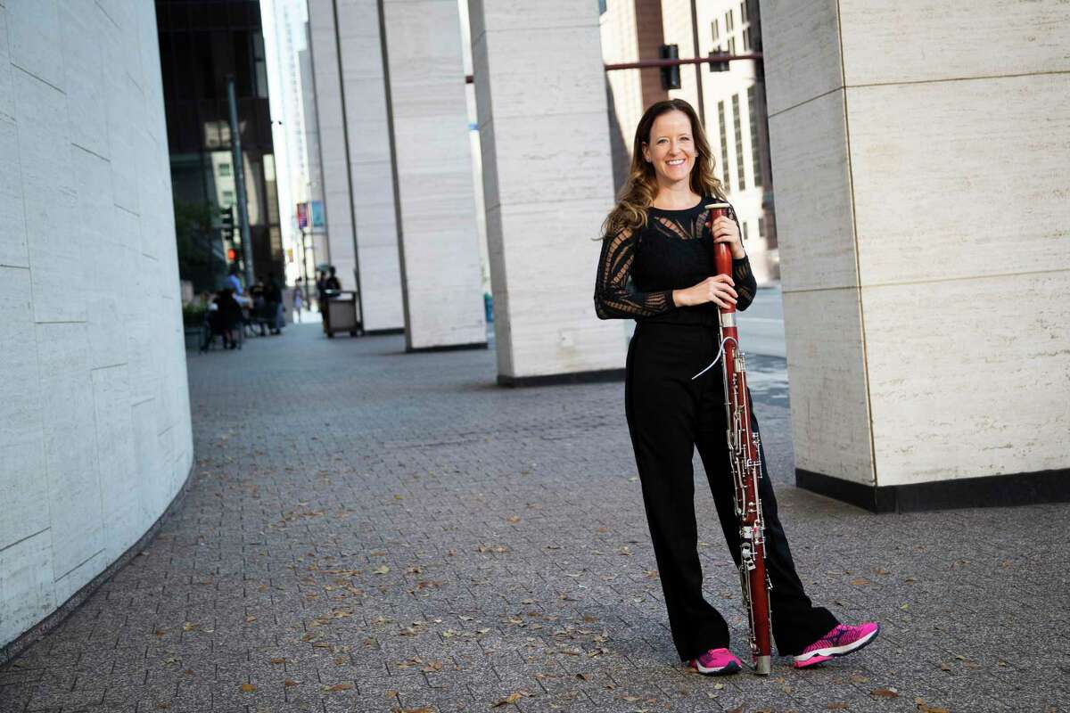 Elise Wagner holds her bassoon while wearing her running shoes by the Jesse H. Jones Hall for the Performing Arts on Wednesday, Nov. 6, 2019, in Houston. Wagner, who is also a runner, has been a member of the Houston Symphony bassoon section since September 2008. Wagner focuses in exercising because it's important for her breathing, and overall core support, which makes her a better musician.