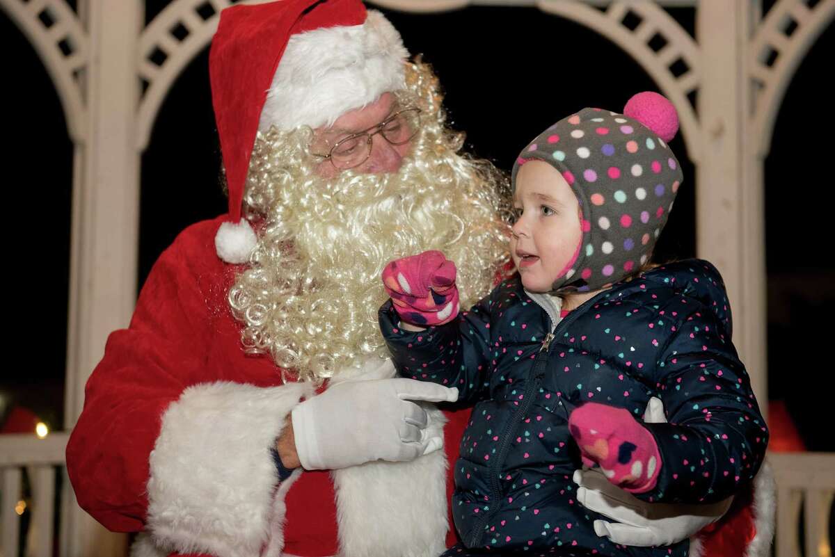 Amelia Sclafani, 3, of Wilton lets Santa know what she wants for Christmas.