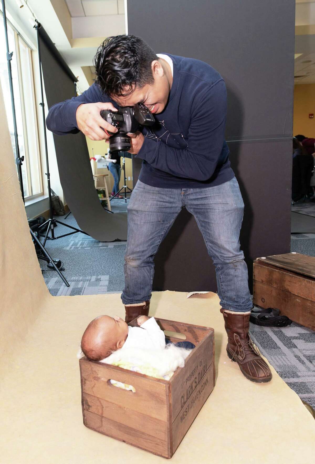 The Community Health Center of Middletown hosted its annual Help-Portrait event at the clinic, 675 Main St., Saturday. Here, an infant gets a portrait taken in an inventive way.