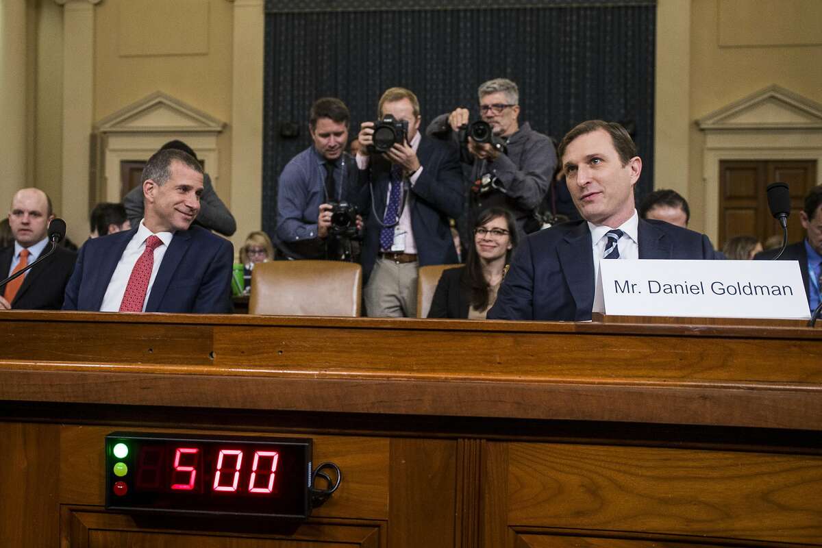 Staff lawyer Stephen Castor, representing the minority Republicans, speaks to staff lawyer Daniel Goldman, representing the majority Democrats, as they return after a break during a House Judiciary Committee hearing in the Longworth House Office Building on Capitol Hill December 9, 2019 in Washington, DC. The hearing is being held for the Judiciary Committee to formally receive evidence in the impeachment inquiry of President Donald Trump, whom Democrats say held back military aid for Ukraine while demanding they investigate his political rivals. The White House declared it would not participate in the hearing.