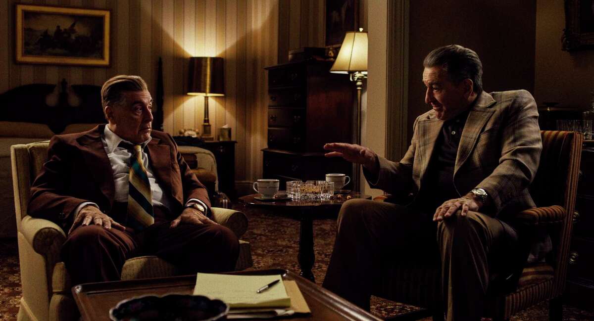 This image released by Netflix shows Al Pacino portraying Jimmy Hoffa, left, and Robert De Niro as Frank Sheeran in a scene from "The Irishman."(Netflix via AP)