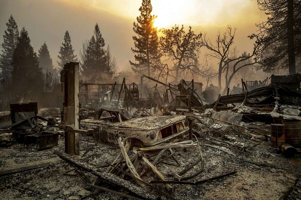 FILE - This Nov. 8, 2018, file photo shows a vintage car among debris after the Camp Fire tears through Paradise, Calif. California officials said Tuesday, Nov. 19, 2019, that crews have finished removing millions of tons of debris left by a Northern California wildfire that killed 85 people and virtually annihilated a town. The Camp Fire was the deadliest and most destructive wildfire in state history. (AP Photo/Noah Berger, File)