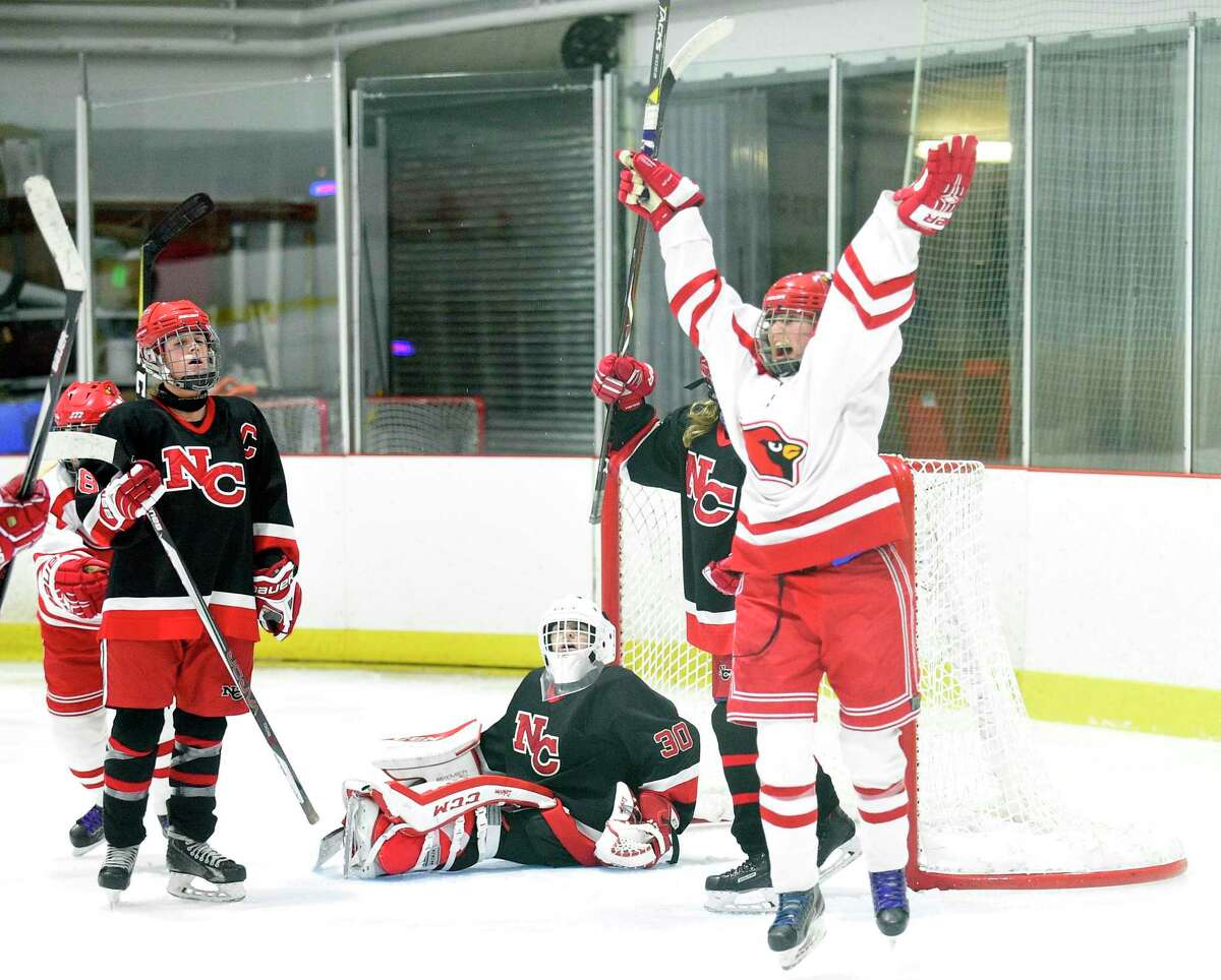 Greenwich’s Emma Wingrove (12) scores the winning goal against New Canaan goalie Blythe Novick during the FCIAC girls ice hockey championship at the Darien Ice Rink on Feb. 24, 2018 in Darien. Greenwich won 2-1.