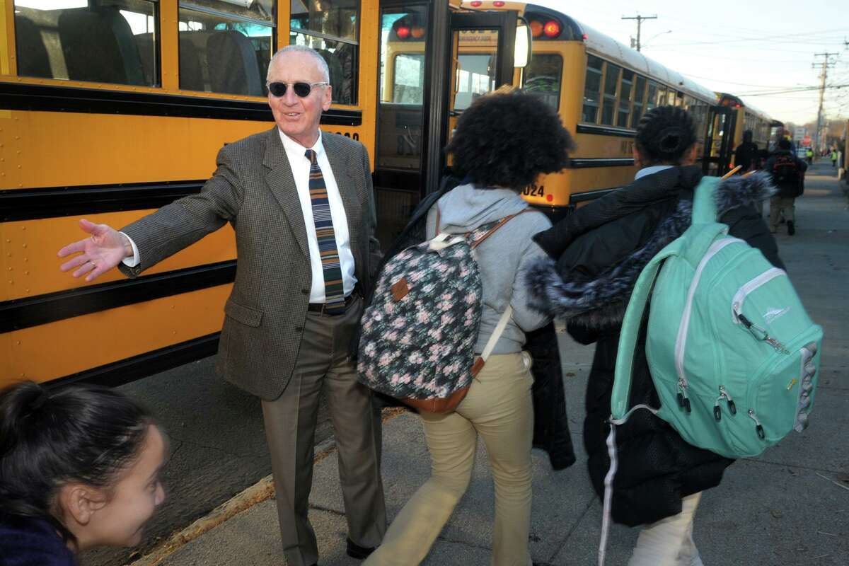 Principal Bruce Ravage watches as his student head to buses lined up along Mountain Grove Street outside of Park City Prep Charter School, in Bridgeport, Conn. Nov. 26, 2019.