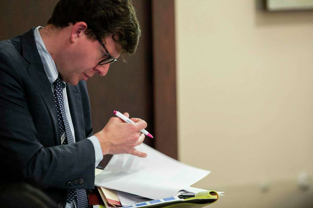 Defense attorney John Hunter looks over paperwork on Monday, Dec. 9, 2019, in the murder trial of Mark Howerton. Hunter is representing Howertown, of Tyler.