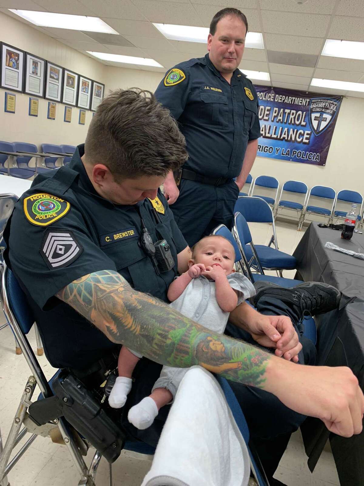 A Houston police officer brought her child to the station and these photos are of Sgt. Christopher Brewster holding the baby. Brewster was gunned down Saturday responding to a domestic violence call in east Houston. Photo courtesy Houston police officer Brooke Chavez.