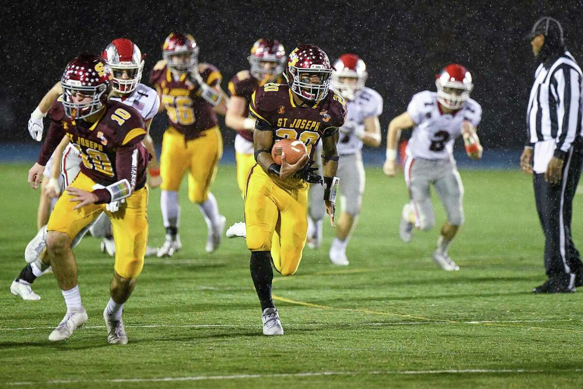 St. Joseph’s Jaden Shirden outruns everyone for his third touchdown against New Canaan in the CIAC Class L Semi-final game at Bunnell High School, Monday December 9, 2019