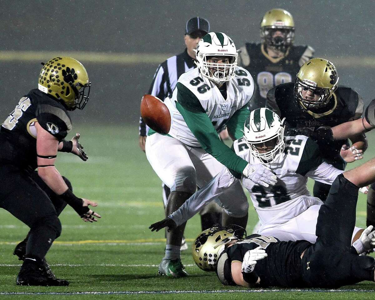 Maloney’s Stone Deleon fumbles the ball in the first half against Hand on Monday.