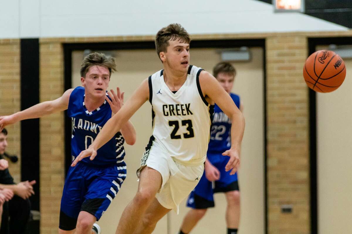 Bullock Creek senior Ian Bissell grabs a loose ball against Gladwin on Monday,Dec 9 at Bullock Creek High School. (Cody Scanlan/for the Daily News)