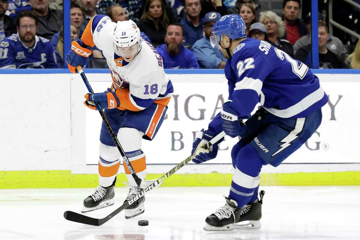 New York Islanders left wing Anthony Beauvillier (18) moves the puck past Tampa Bay Lightning defenseman Kevin Shattenkirk (22) during the third period of an NHL hockey game Monday, Dec. 9, 2019, in Tampa, Fla. (AP Photo/Chris O'Meara)