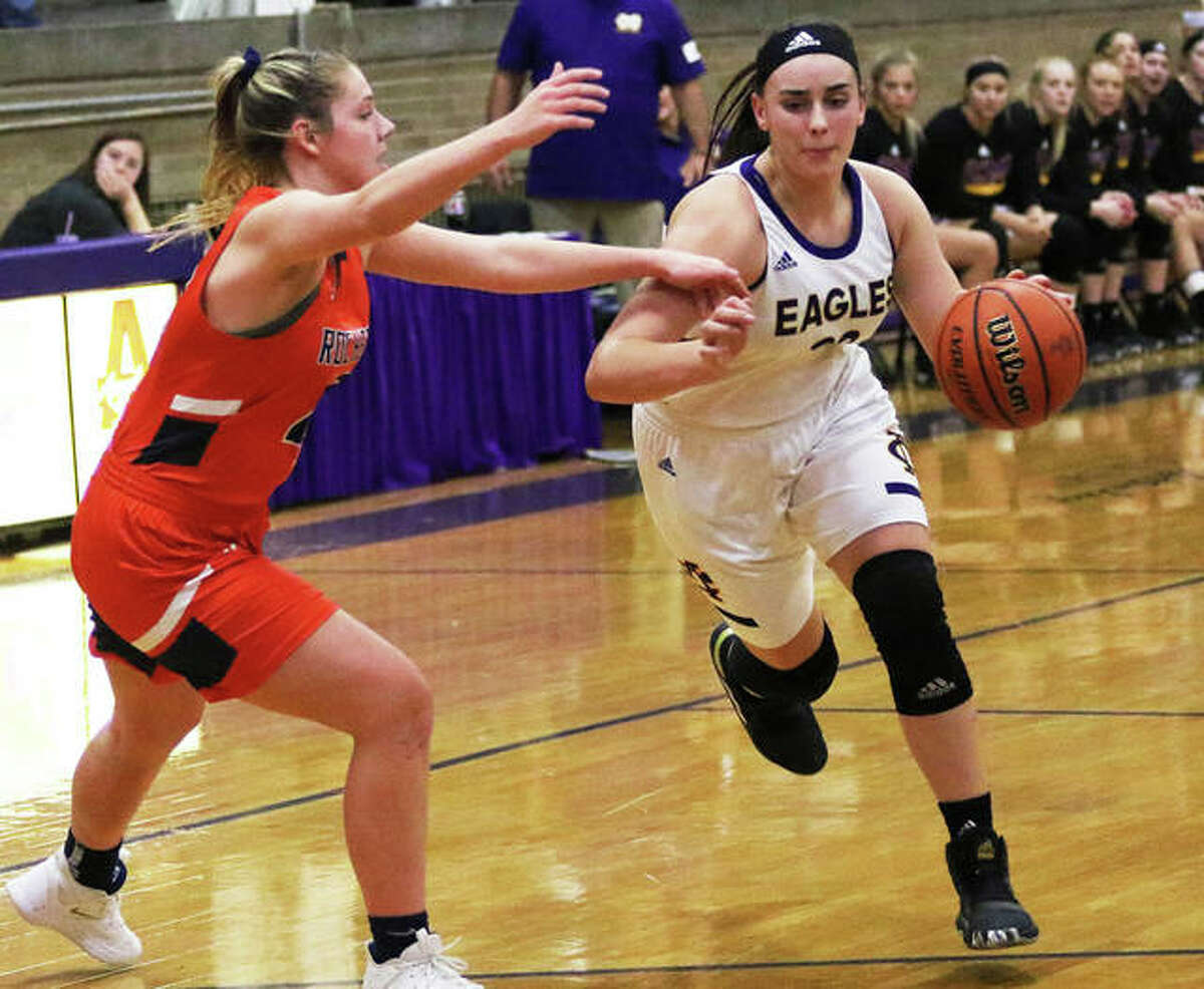 CM’s Anna Hall (right), shown driving on a Rochester defender during the Taylorville Tourney on Nov. 30, scored 22 points Monday night to lead the Eagles to a MVC victory over Triad in Troy.