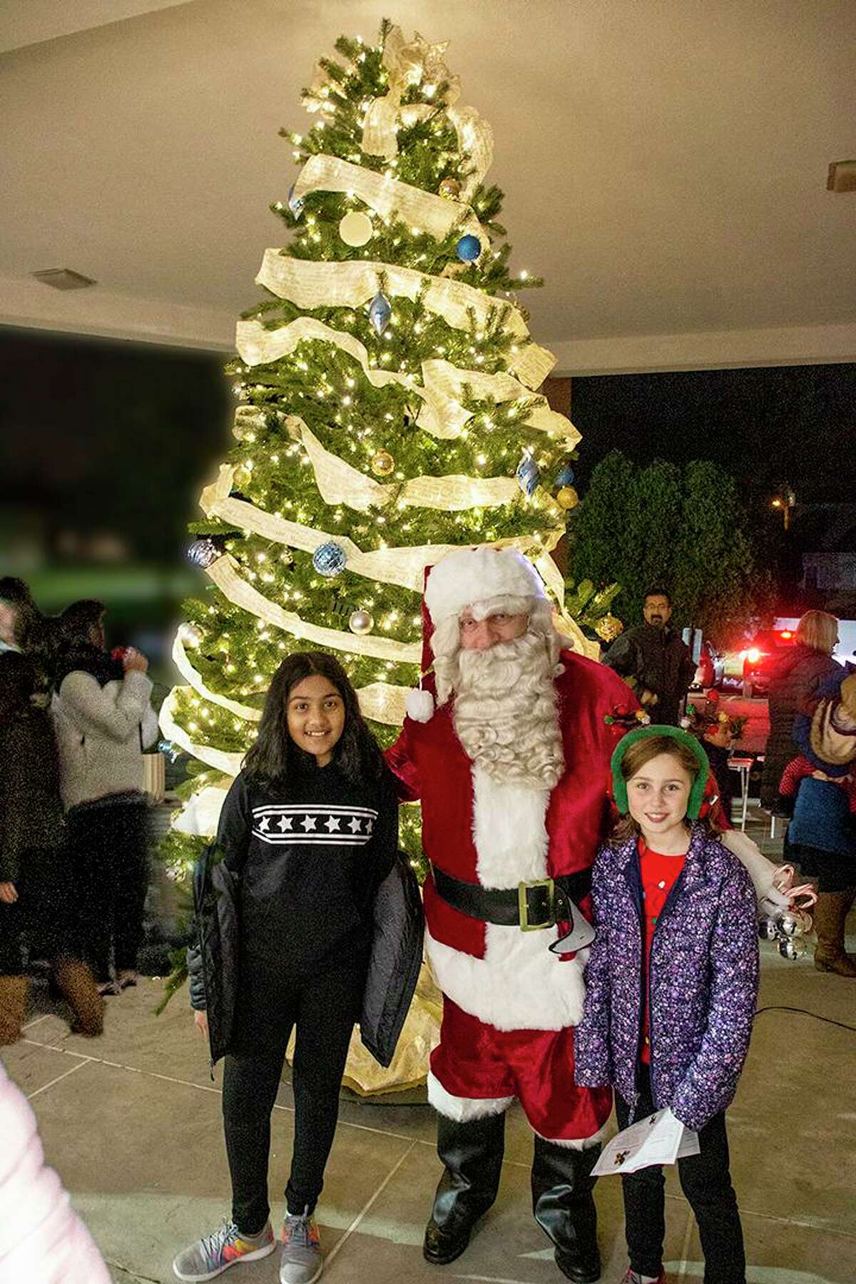 Santa Claus (played by  a member of St. George’s Knights of Columbus Council 3928) suprised East Shoreline Catholic Academy’s students at a Christmas tree lighting event held Dec. 4.