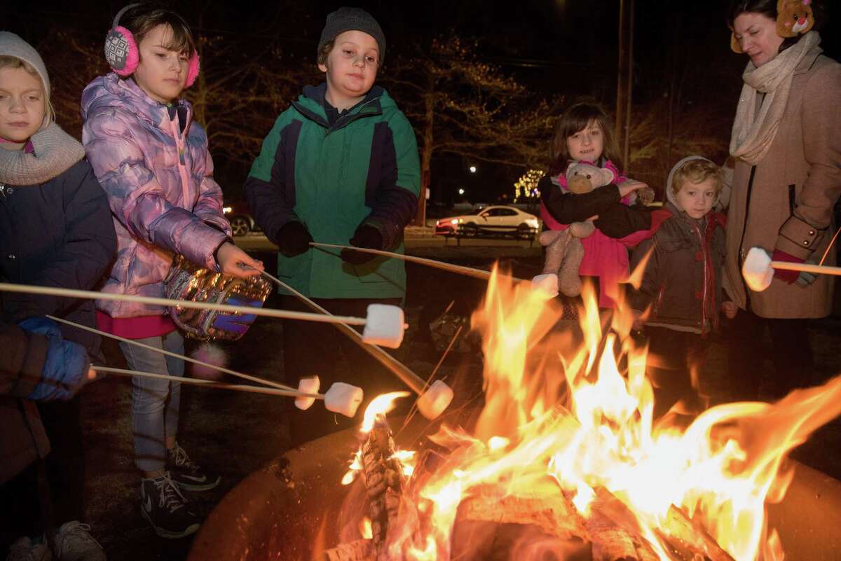 Kids toasted marshmallows over a fire at the Ridgefield Holiday Stroll on Friday, Dec. 6, 2019 in Ridgefield.