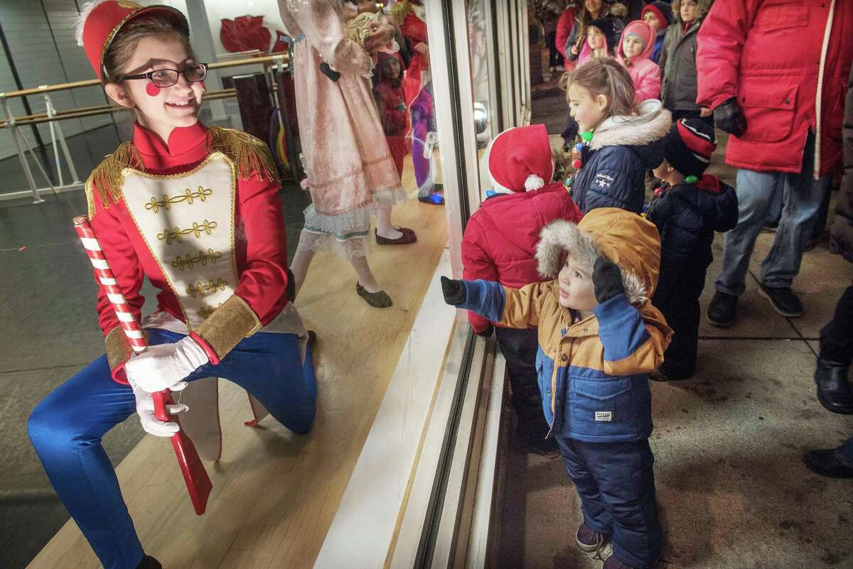 Ronan Carloni, 2, is entertained by a Nutcraker dancer from the Ridgefield Conservatory of Dance at the Ridgefield Holiday Stroll on Friday, Dec. 6, 2019 in Ridgefield.