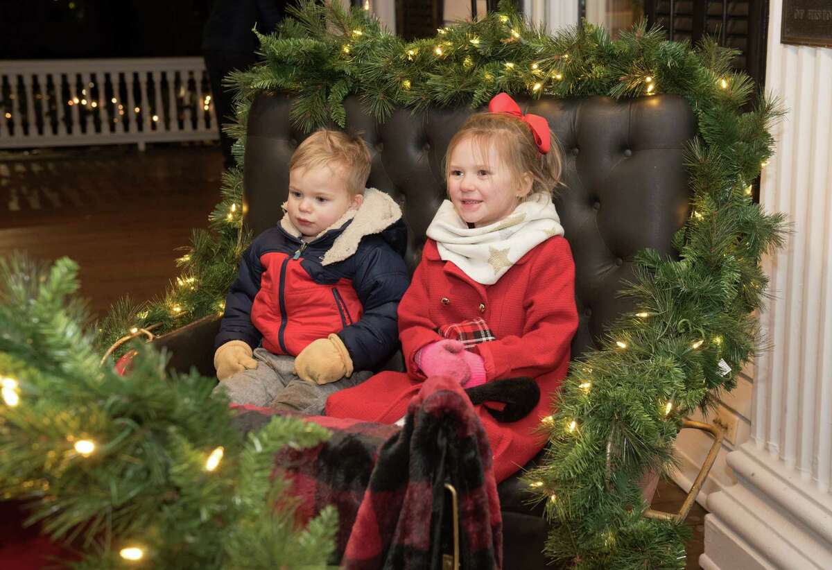 Max O’Keefe,2, and sister, Charley, 4, sit in a vintage sleigh at the Lounsbury House at the Ridgefield Holiday Stroll on Friday, Dec. 6, 2019 in Ridgefield.