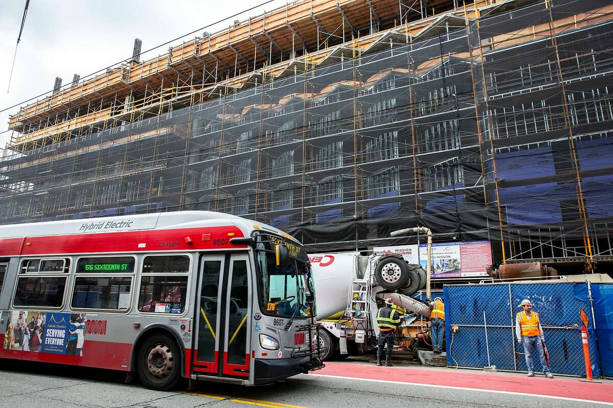 The 55-Sixteenth Street bus drives past the construction site at 950 Mission Street on Tuesday, Dec. 10, 2019, in San Francisco, Calif.