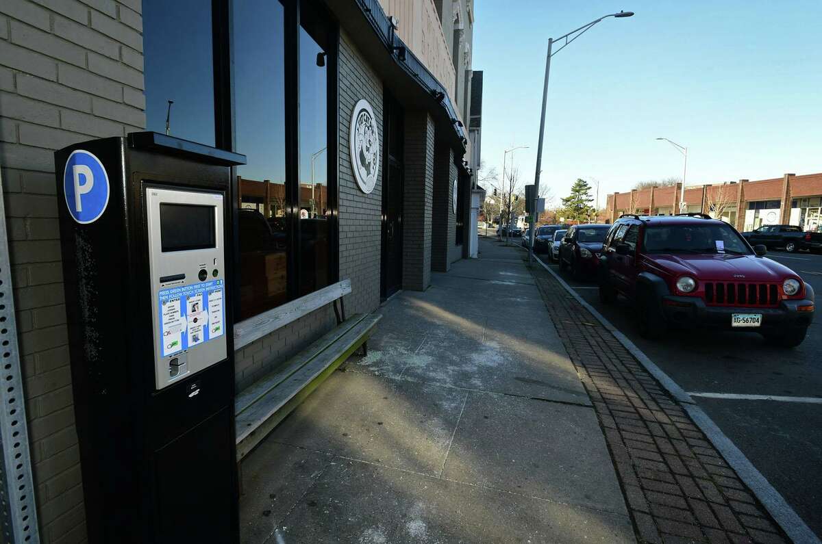 Parking kiosks in the Wall Street area Saturday, December 7, 2019, in Norwalk, Conn. The city has suspended enforcement in the area until they can find a better solution for metered parking that will satisfy area businesses in the distict. The city has covered signs and to clarify parking is temporarily free and lines have been painted on High Street to delineate street parking within the Wall Street master parking plan.