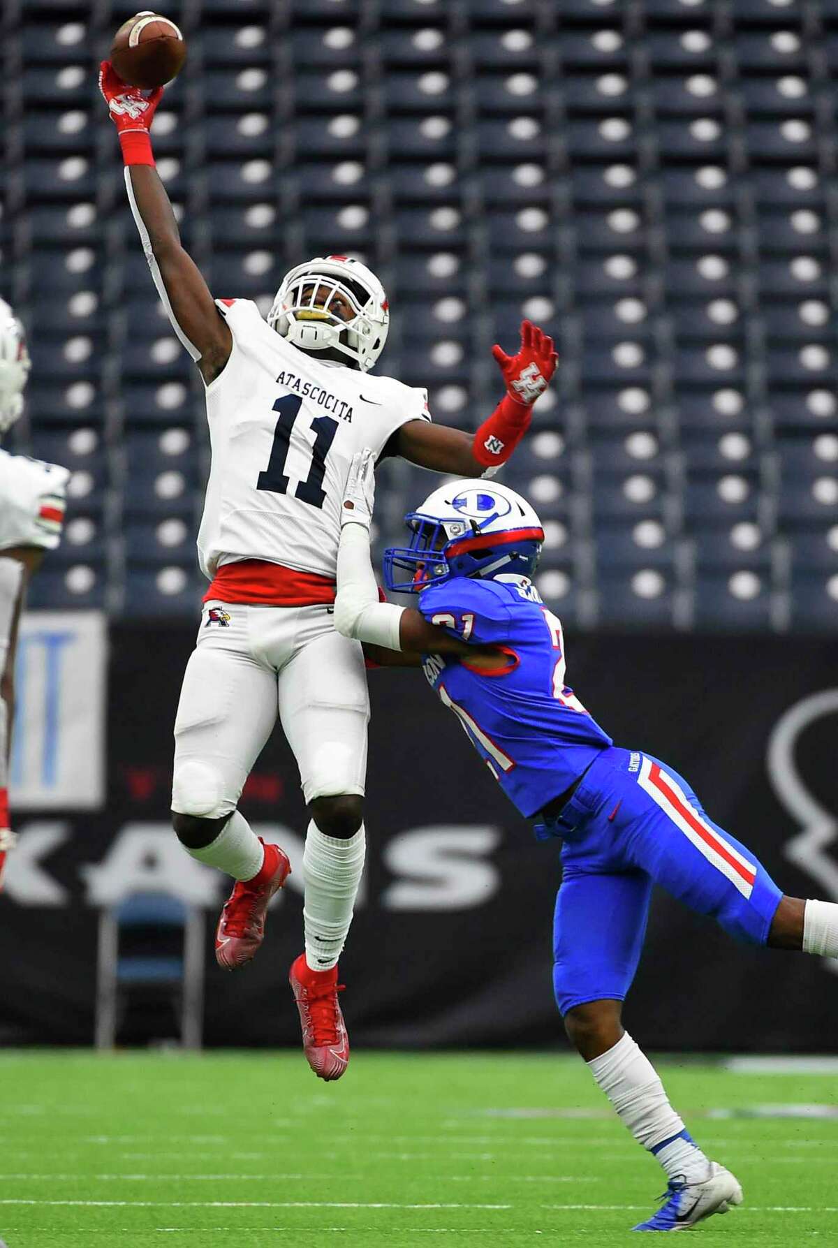 Atascocita wide receiver Dylan Robinson (11) misses a pass as Dickinson defensive back Savien Arnett defends during the first half of a high school football playoff game, Saturday, Nov. 23, 2019, in Houston.