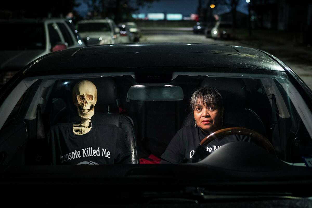 Leisa Glenn sits in her car with a skeleton her group has dubbed "Creosote Man" in their Fifth Ward neighborhood on Thursday, Dec. 5, 2019, in Houston. A cancer cluster was identified in the the historically black north Houston neighborhoods of the Fifth Ward and Kashmere Gardens, near a site of legacy contamination from rail yard operations. The cancers identified in the cluster are associated with the contaminants found in creosote, experts said.