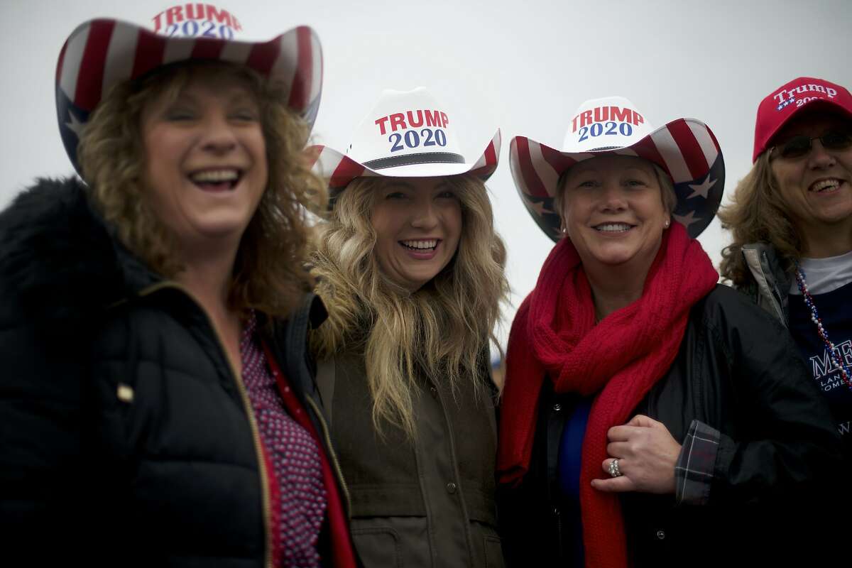 HERSHEY, PA - DECEMBER 10: Trump supporters (L-R) Lisa Reed, Meredith Reed, Helen Williams, Michelle Weller wear cowboy hats stating "TRUMP 2020" while waiting in the rain before U.S. President Donald J. Trump holds a campaign rally on December 10, 2019 in Hershey, Pennsylvania. This rally marks the third time President Trump has held a campaign rally at Giant Center. U.S. Vice President Mike Pence is also slated to attend, signifying the importance Pennsylvania holds as a key battleground state. (Photo by Mark Makela/Getty Images)