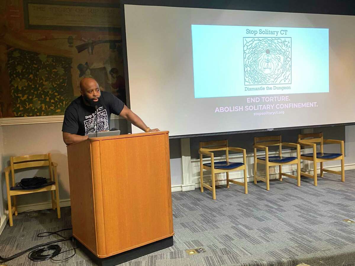 Leighton Johnson of Stop Solitary CT speaks at a forum held Tuesday at the Ives Memorial Library in New Haven.