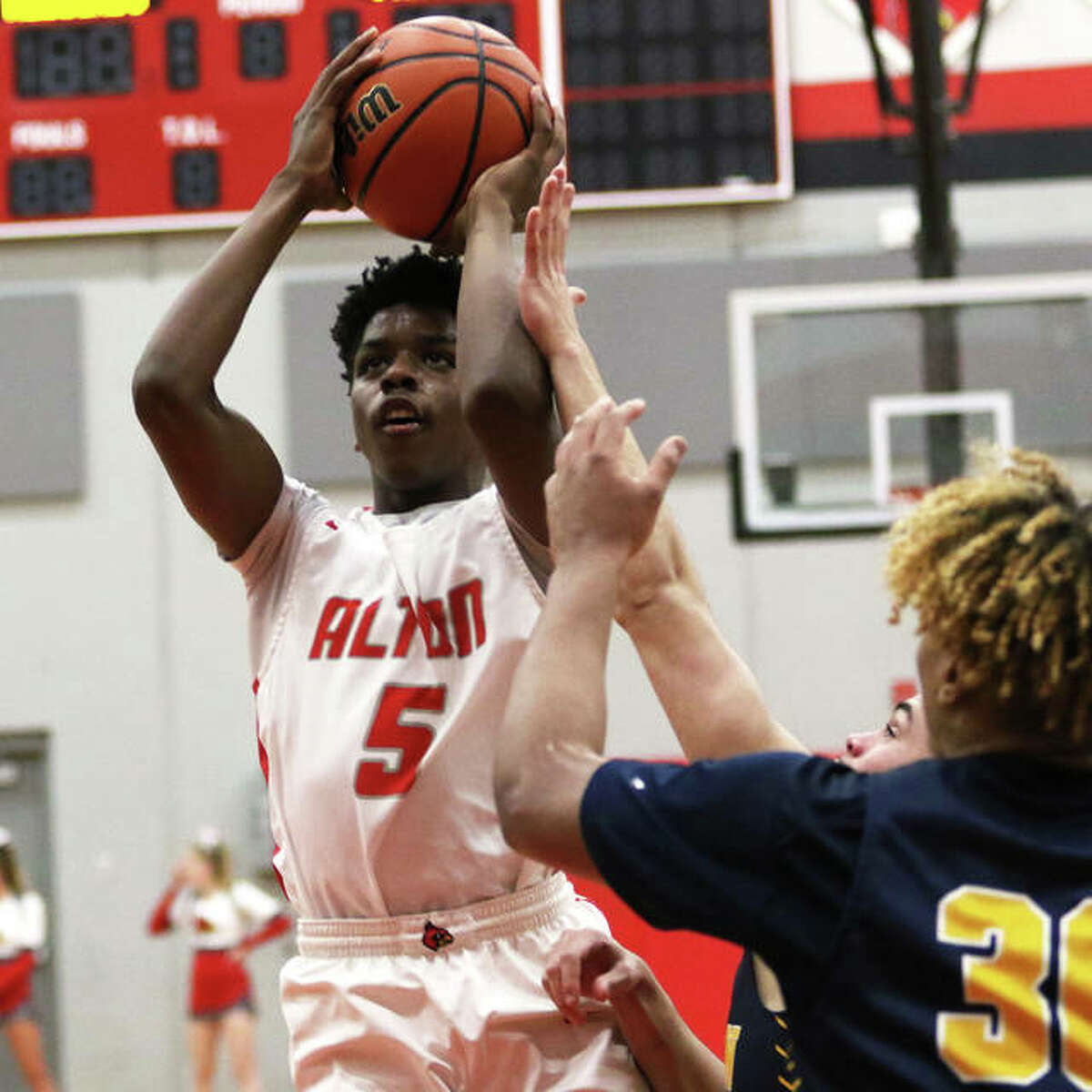 Alton’s Camren Edwards (5) puts up a shot in the lane against the O’Fallon Panthers on Tuesday night in Godfrey.