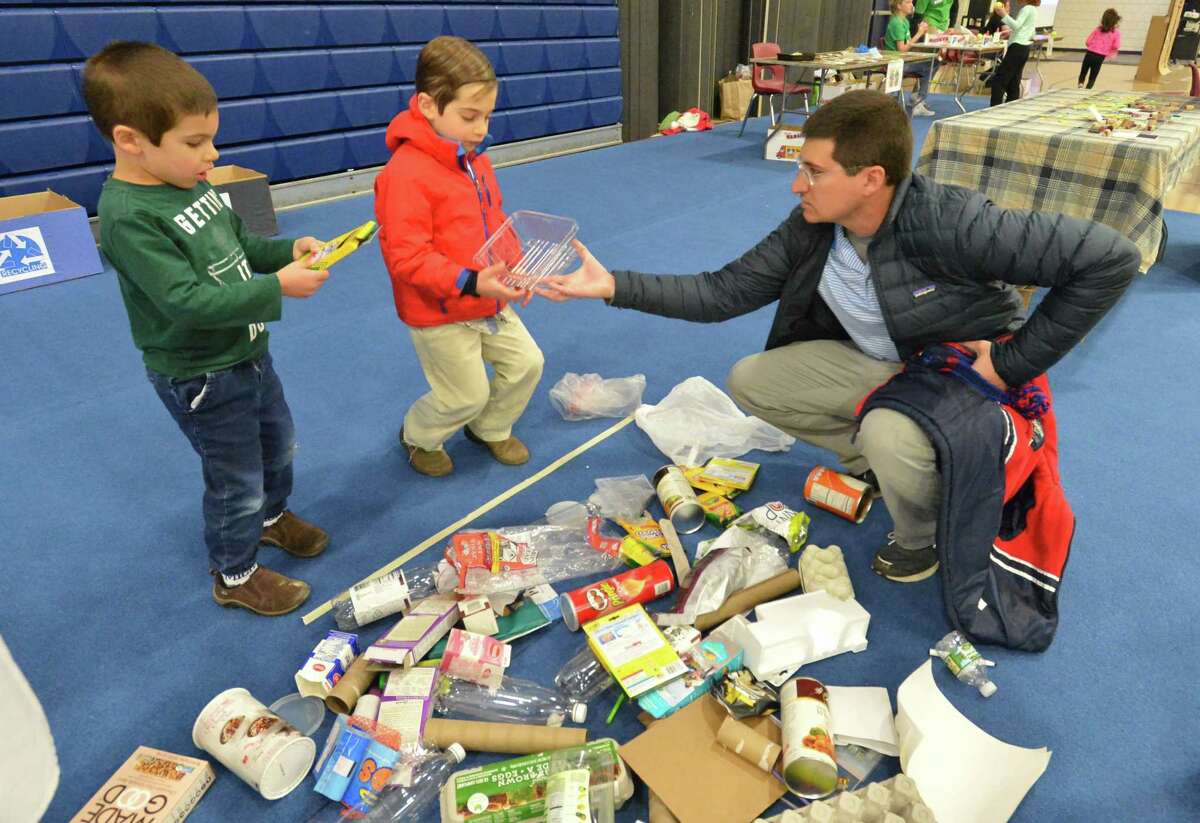 Brothers Greg and Blake Vasse learn about recycling with father Greg at the 2018 Zero-Waste Faire.
