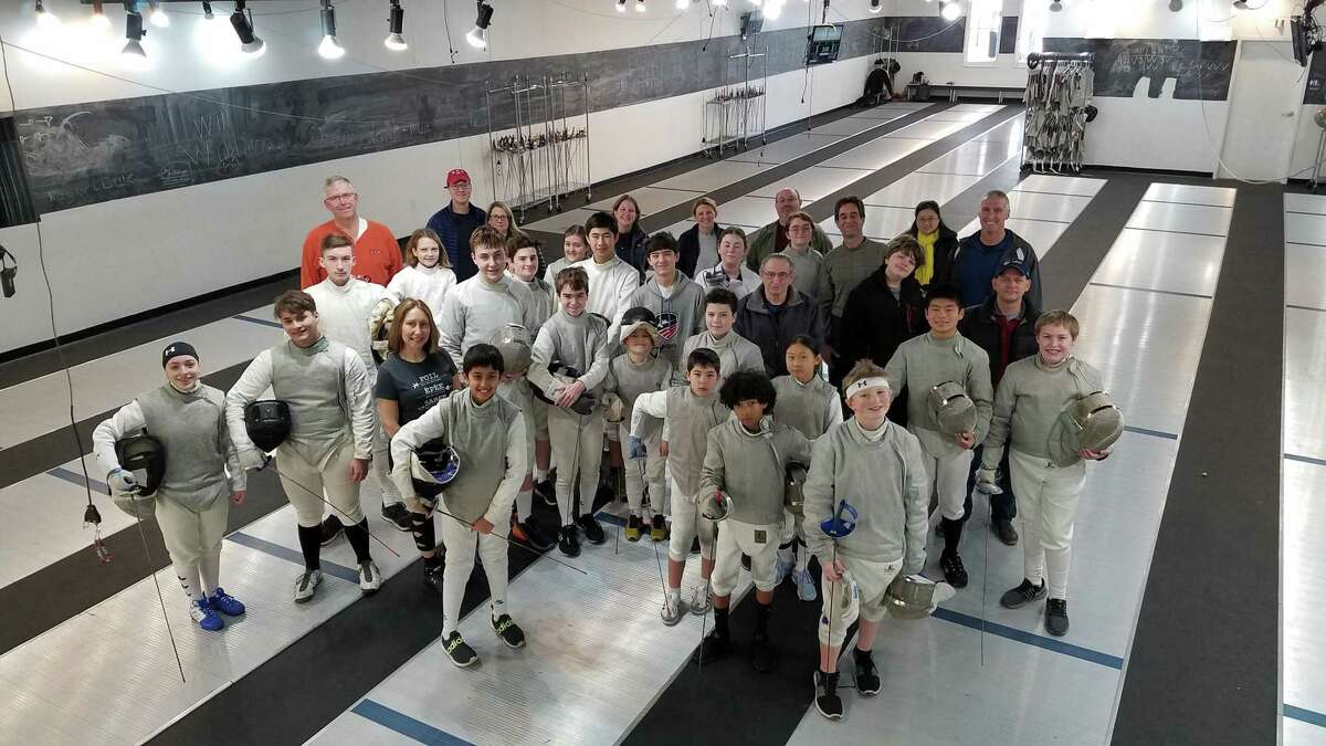 Fencing students gather for a group photo inside the Way of the Sword training facility on Governor Street in Ridgefield.