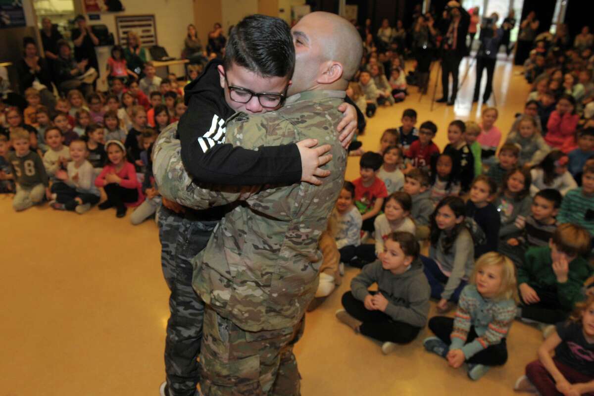 Fifth-grader Joshua Ochoa hugs his father, US Army Staff Sgt. Joshua Ochoa, after a surprise meeting between the father and son during an assembly at Scotland Elementary School, in Ridgefield, Conn. Dec. 10, 2019. Sgt. Ochoa just returned from a tour of duty in Djibouti, Africa.